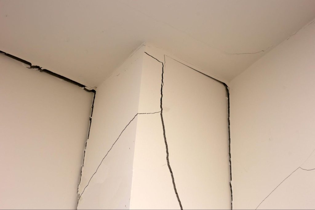 Scheuren in binnenmuren door mogelijke verzakking of structurele problemen.